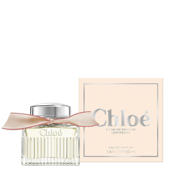 50 ml clear glass perfume bottle with beige ribbon and silver cap, floral scent