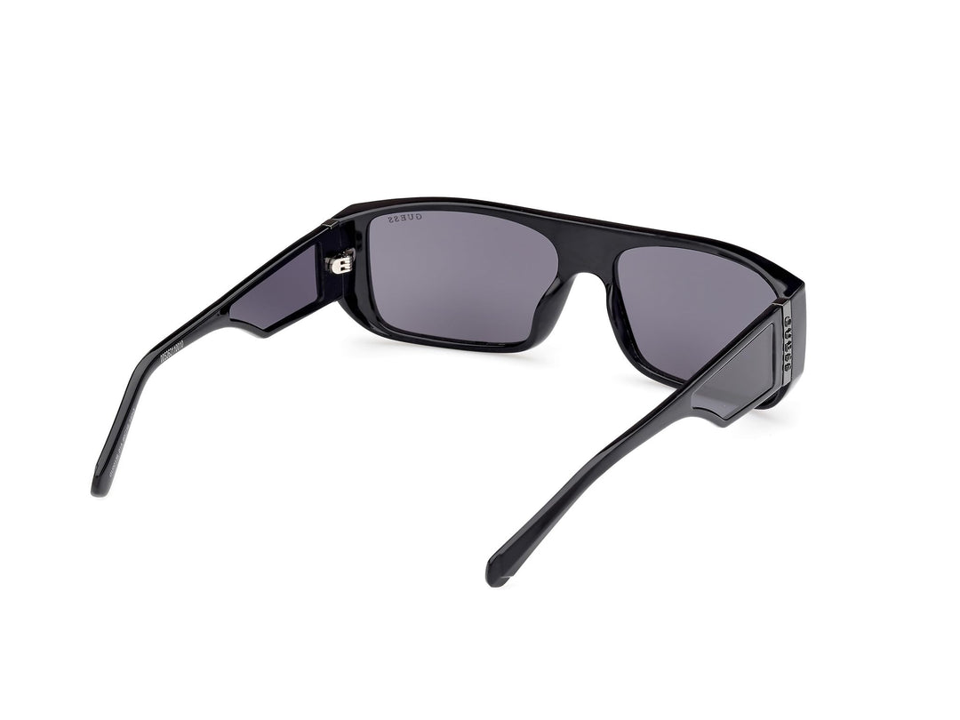 Guess rectangular black plastic sunglasses with thick frame, dark tinted lenses, straight temples, lens logo