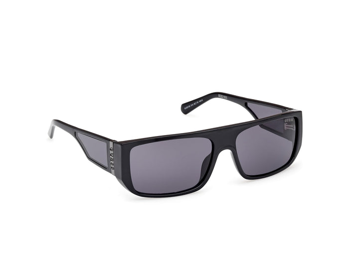 Guess rectangular black plastic sunglasses with thick frame, dark tinted lenses, straight temples, lens logo