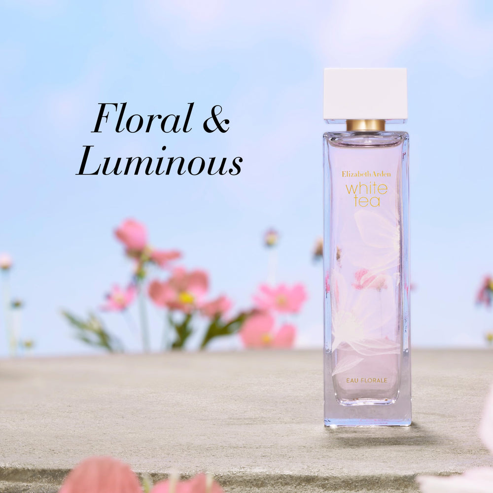 Slim clear bottle with soft pink perfume and gold cap, 100 ml