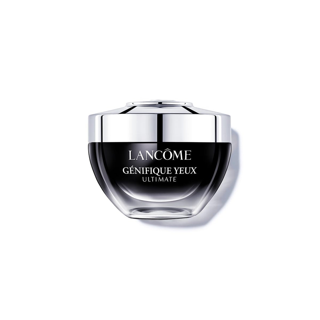 Lancôme Génifique eye cream jar beside applicator on neutral background