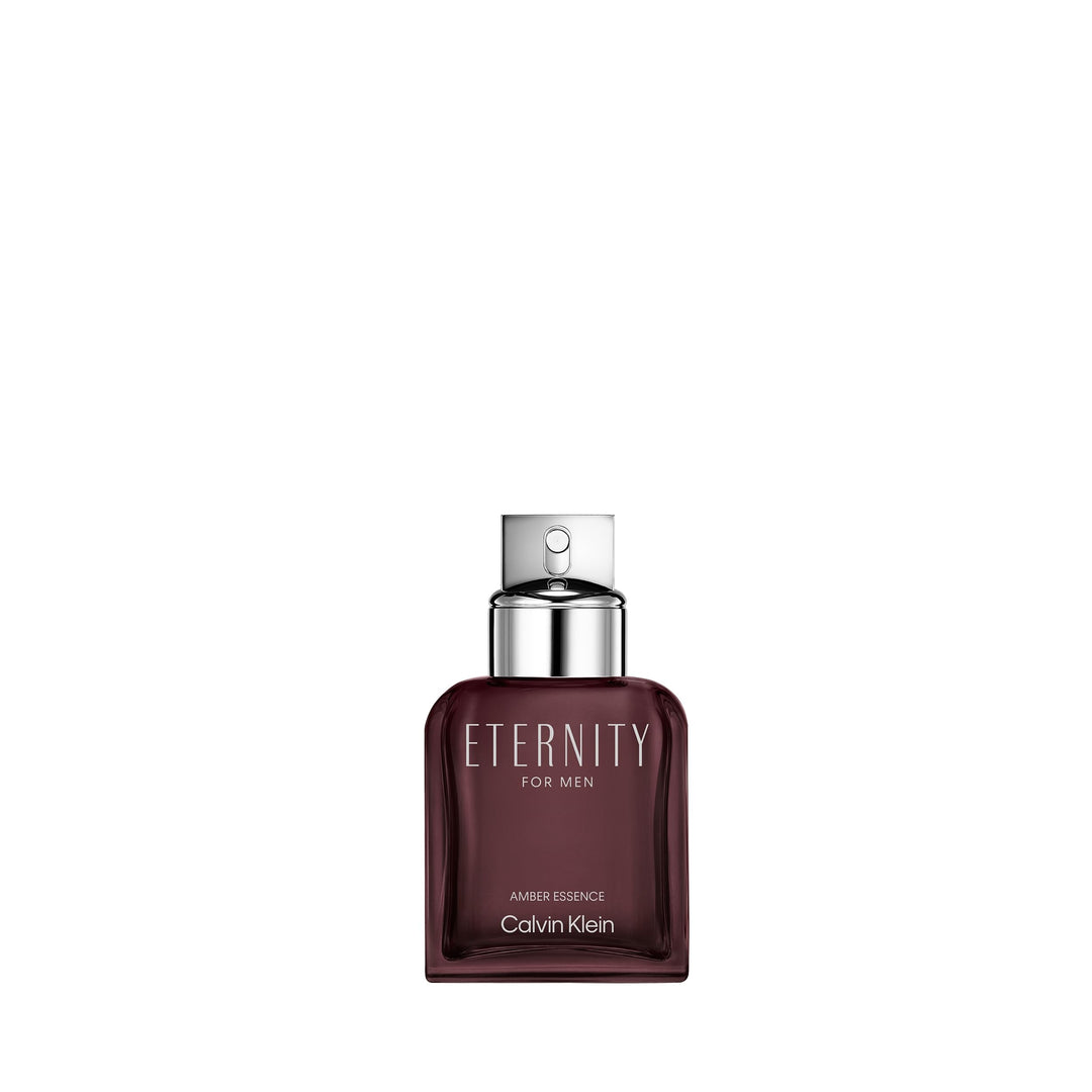 Calvin Klein Deep burgundy glass perfume bottle with metallic silver cap and minimalist labeling, modern silhouette.
