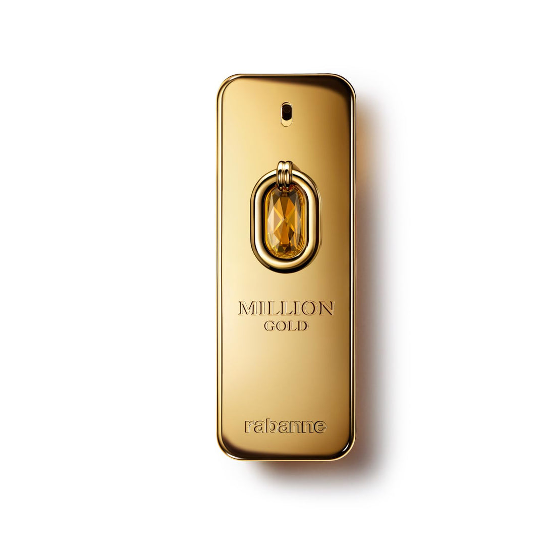 Rabanne Gold-toned hexagonal perfume bottle with textured finish and faceted cap, photographed on warm background.