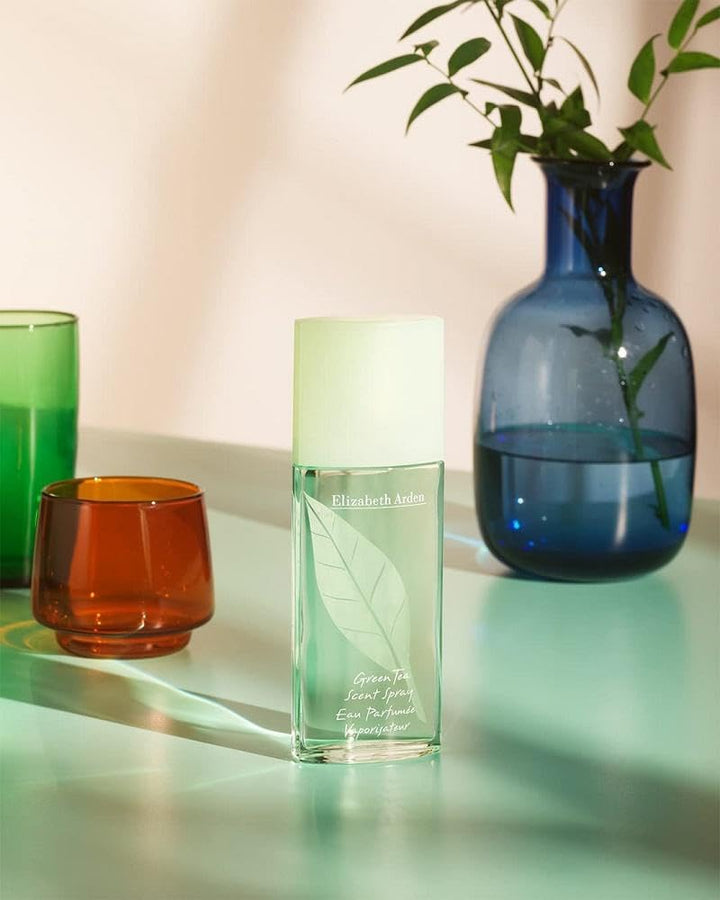 Elizabeth Arden Light yellow shower gel in transparent plastic bottle with pump, green leaf graphic and label