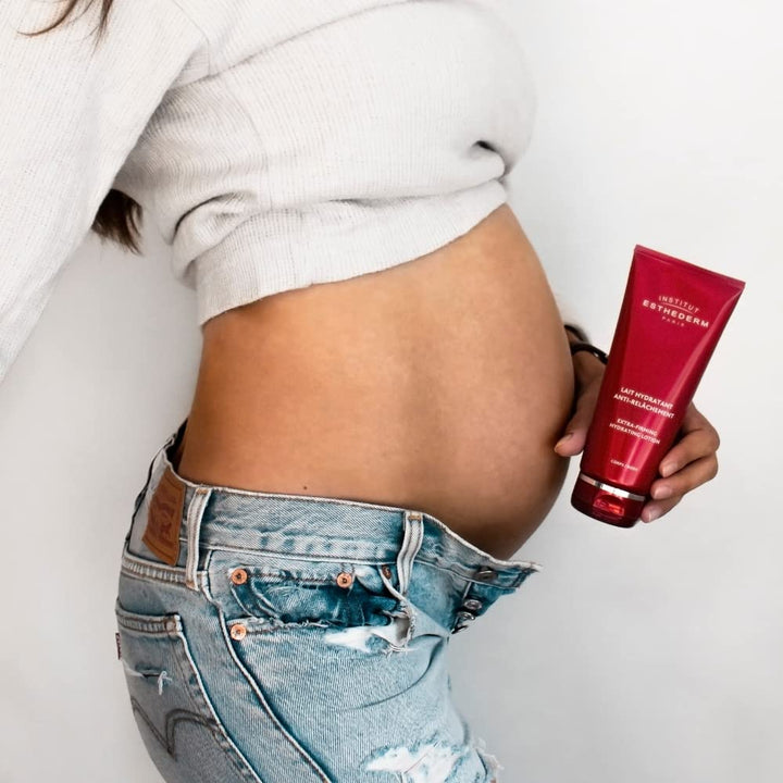 Bottle of Institut Esthederm firming body milk with clean, elegant packaging
