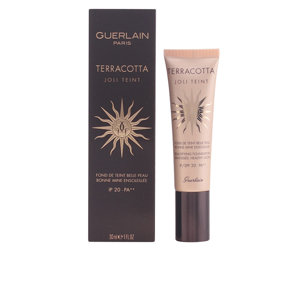 Black and beige tube with gold sun emblem, plastic tube and cardboard box, Guerlain