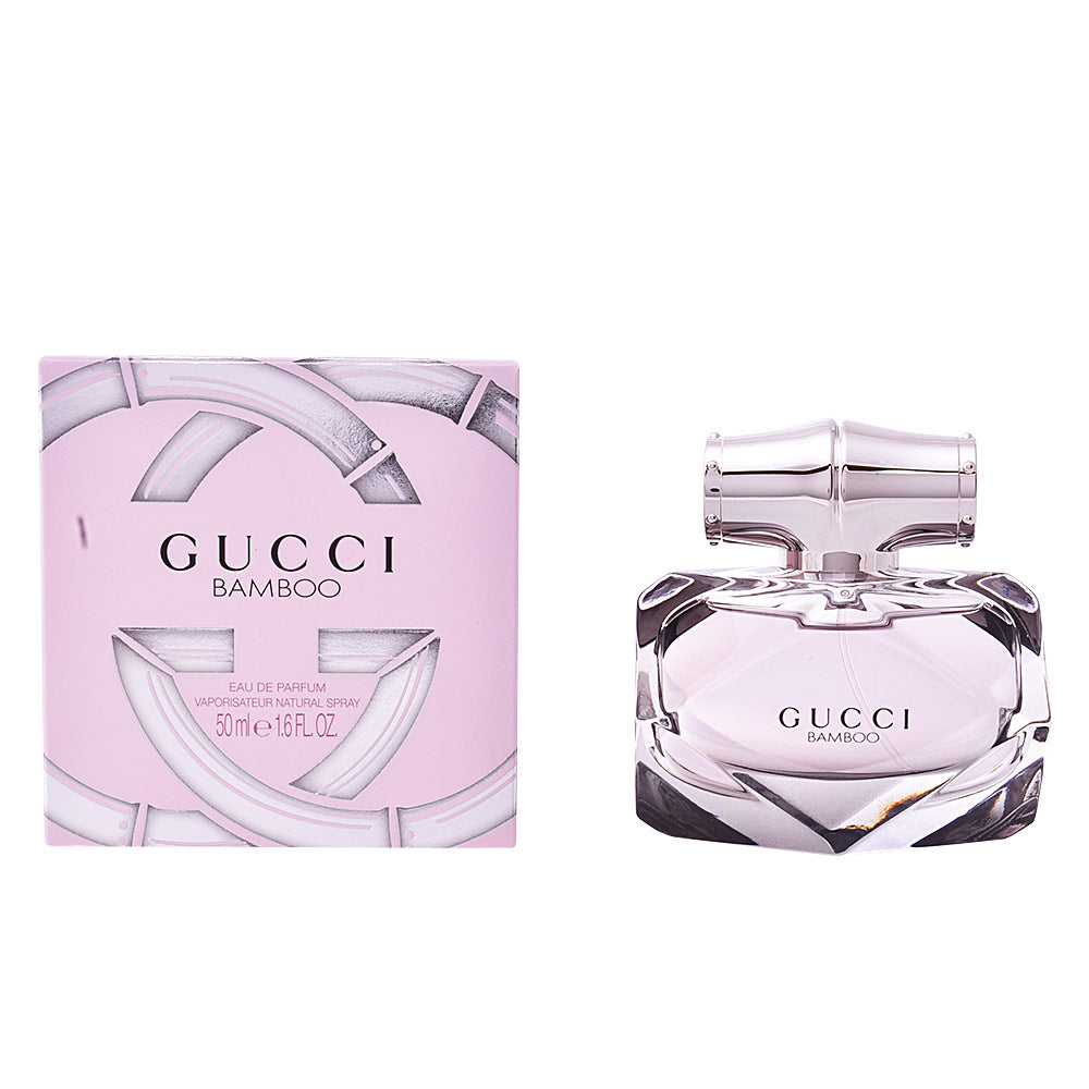 Gucci Light pink rectangular box and transparent glass perfume bottle with silver bamboo-shaped cap, refined detailing .