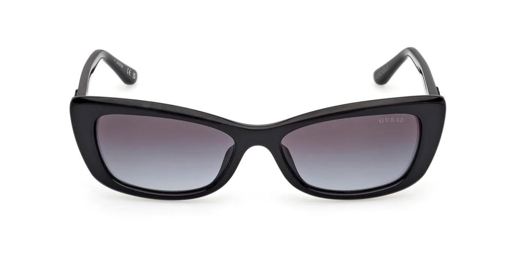 Black cat-eye sunglasses in glossy plastic with gradient lenses and Guess logo on temple and lens