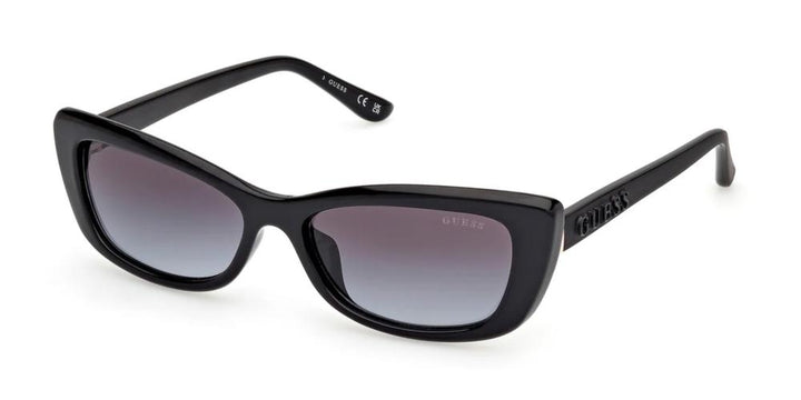 Black cat-eye sunglasses in glossy plastic with gradient lenses and Guess logo on temple and lens