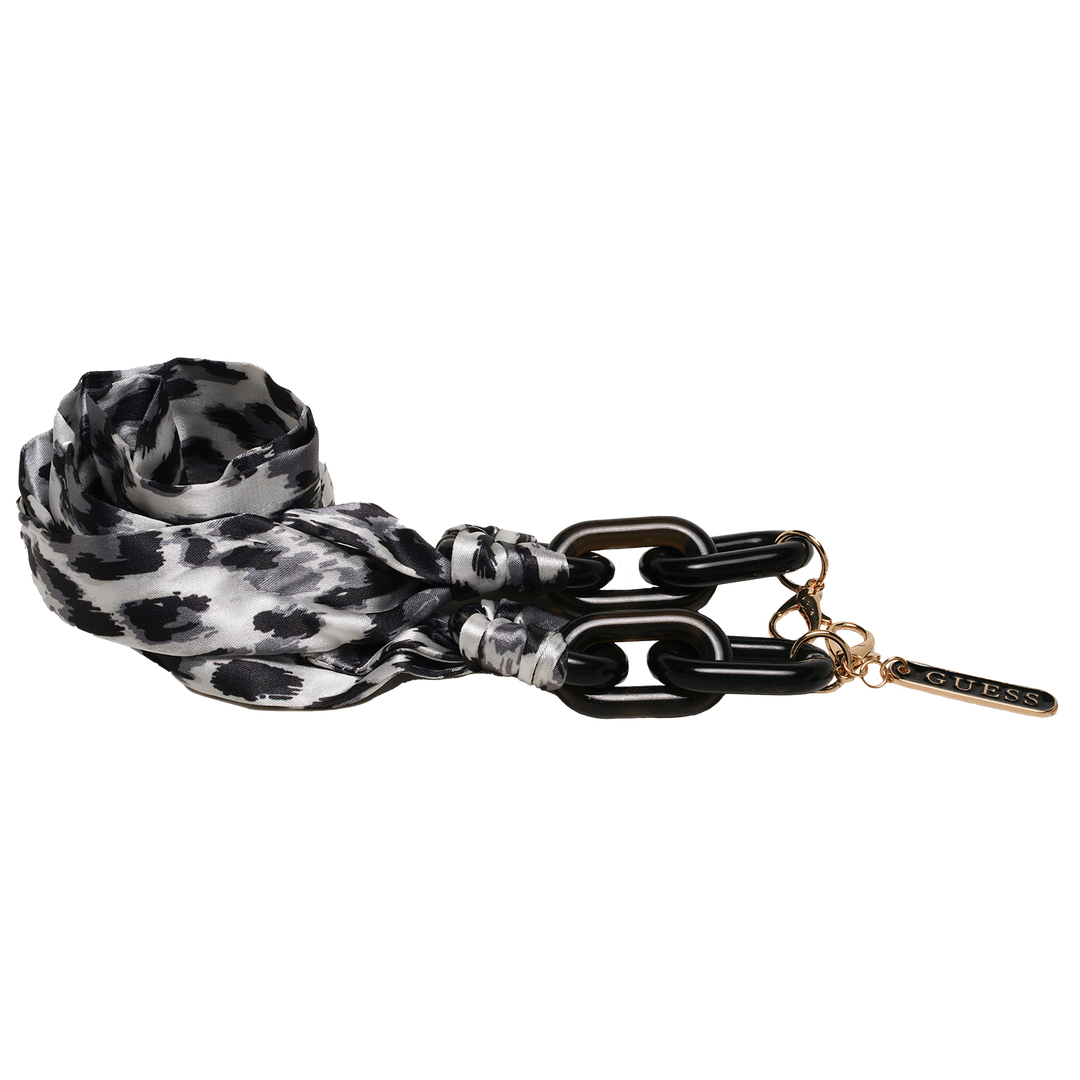 Black and gold cat-eye eyeglasses with thin metal temples and patterned fabric strap laid on white background