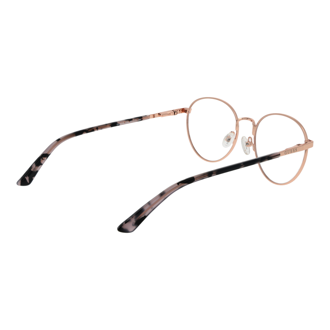 Rose gold thin metal round eyeglasses with tortoiseshell temple tips on neutral background