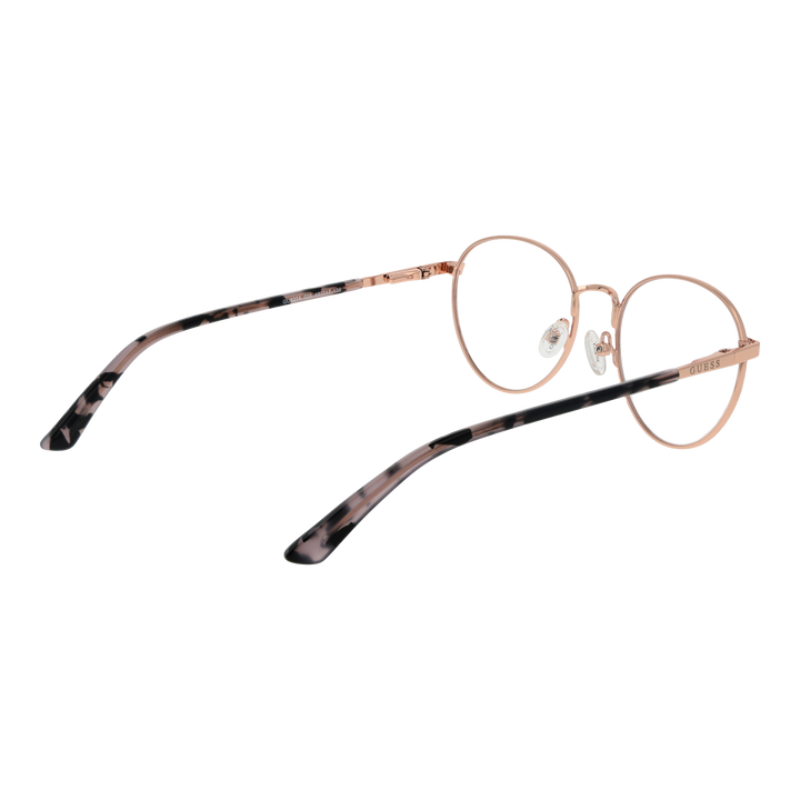 Rose gold thin metal round eyeglasses with tortoiseshell temple tips on neutral background