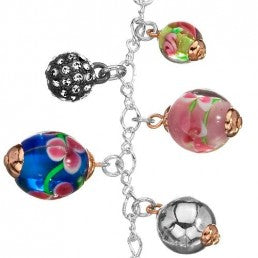 Silver chain necklace with colorful floral beads and heart pendant on pale background