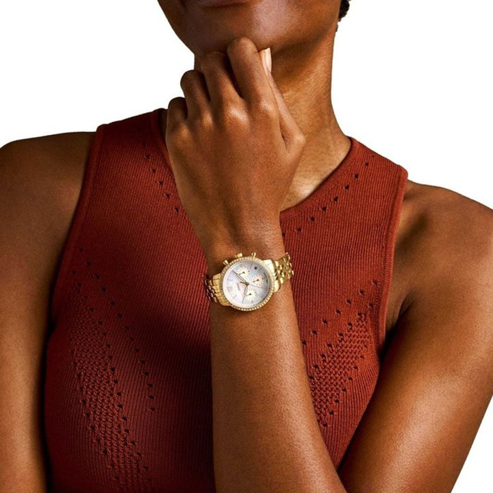 Gold-tone chronograph wristwatch with mother-of-pearl dial and crystal-studded bezel on bracelet
