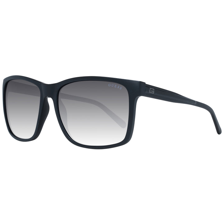 Black rectangular sunglasses on neutral background with gradient lenses and visible logo on temple